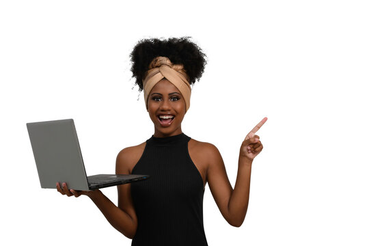 woman with laptop looking at camera and pointing to the right side of the image, black woman
