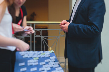 Process of checking in on a conference congress forum event, registration desk table, visitors and...