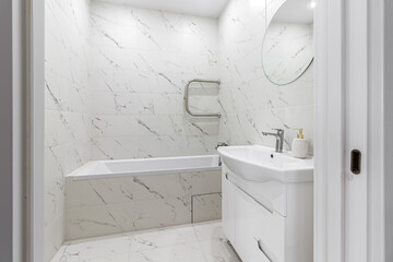 Bright space - a silver tap in a white bathroom.