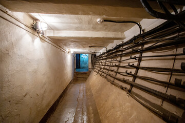 Abstract dark corridor of military bunker interior, grungy old underground tunnel. Nuclear shelter