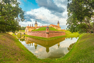 Nesvizh Castle in Belarus. Beautiful view in summer with picturesque sky and clouds on background