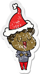 laughing distressed sticker cartoon of a man wearing santa hat