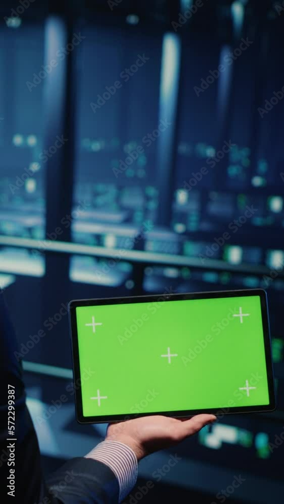 Poster vertical video: it administrator running greenscreen display on tablet, using cloud computing in ren