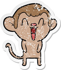 distressed sticker of a cartoon laughing monkey