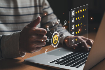Selective focus at finger of business man while point finger to choose feedback on excellent customer service with five star score with smile. Service evaluation concept with futuristic icon.	
