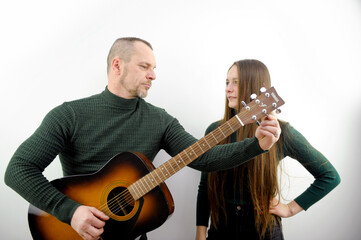 man and woman love Serenade man tunes guitar Music lesson teacher explains How to use instrument...