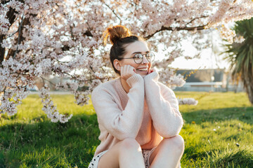 Portrait of young smiling caucasian hipster girl in glasses with pimples, acne on her face. Body...