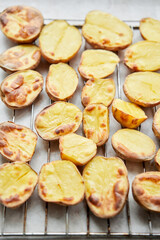 Potato wedges, oven roasted, a close-up in a baking tray. Home cooking. Healthy food, cooked without oil and salt.