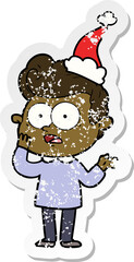 distressed sticker cartoon of a staring man wearing santa hat