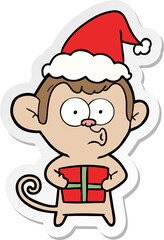 sticker cartoon of a christmas monkey wearing santa hat