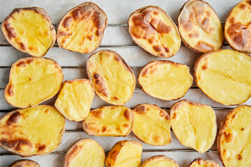 Potato wedges, oven roasted, a close-up in a baking tray. Home cooking. Healthy food, cooked without oil and salt.