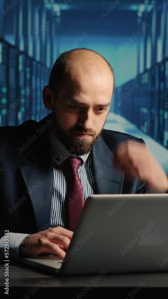 Poster vertical video: frustrated database admin making mistake in data center, working under pressure with