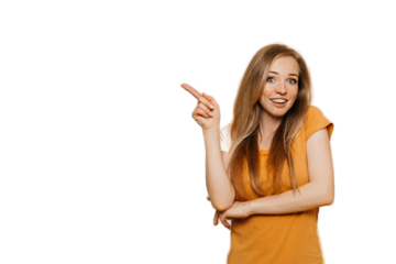 Cute cheerful redhead young woman wears orange casual clothes pointing aside at empty space by index finger, smiles broadly, discount time is on, over transparent background. Happy people concept.