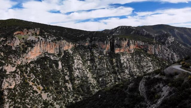 4K drone footage over the mountains of Peloponesus with a little road on the side, Leonidio, Greece.
Mid angle, parallax movement.