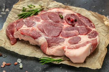 fresh raw pork steak with spices on a dark background, Food recipe background. Close up