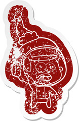 cartoon distressed sticker of a surprised astronaut wearing santa hat