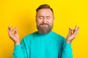 Photo of concentrate groomed man wear trendy clothes eyes closed enjoy free time morning yoga isolated on yellow color background