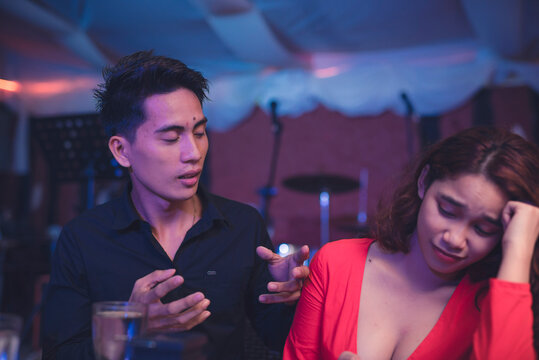 Woman is annoyed with listening to the cocky man's cringey stories of him bragging about his experience with women. Uncomfortable with the topic on a first date. Secondhand embarrassment.
