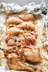 Baked chicken drumsticks without skin. Baked in foil with onions and seasonings. Home cooking. Healthy food, cooked without oil and salt. 