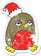 retro distressed sticker of a cartoon christmas robin wearing santa hat
