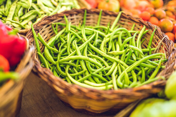 Raw green beans in a basket.