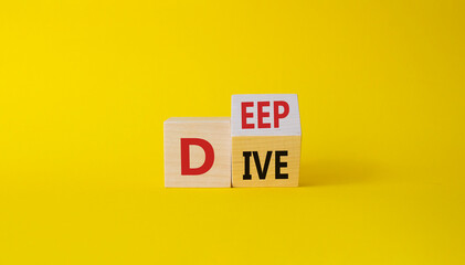 Deep Dive symbol. Concept words deep dive on wooden cubes. Beautiful yellow background. Business and Deep Dive concept. Copy space