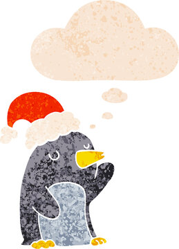 cute cartoon christmas penguin and thought bubble in retro textured style
