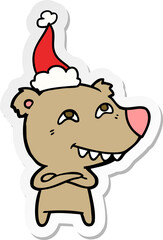sticker cartoon of a bear showing teeth wearing santa hat