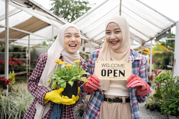 Young Muslim Islam female florists working together at the flower shop, small business and entrepreneurship concept.