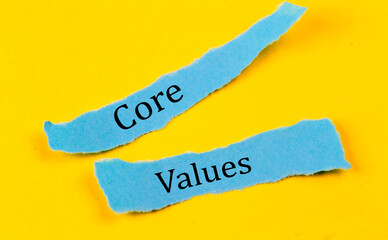 CORE VALUES text on a blue pieces of paper on yellow background, business concept