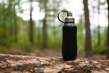 steel bottle of water in the forest