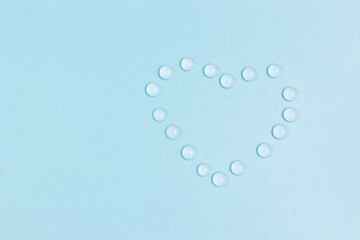 water drops in shape of heart on blue background,save water, world water day  