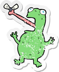 retro distressed sticker of a cartoon frog catching fly