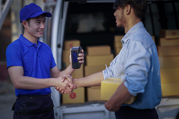Deliver service. Man With Box in Car Outdoors Delivery Man in uniform holds parcel and phone car outdoors Delivery man taking parcels from The Delivery service