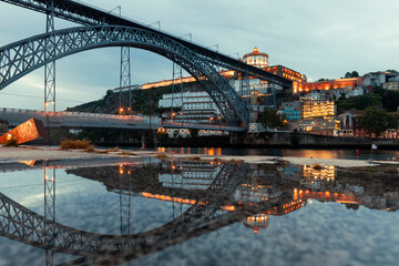 Reflection of the iconic Dom Luis I bridge during dawn in the city of Porto, Portugal