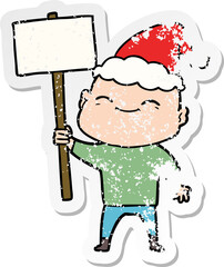 happy distressed sticker cartoon of a bald man wearing santa hat