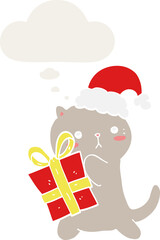 cute cartoon cat carrying christmas present and thought bubble in retro style