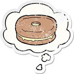 cartoon biscuit and thought bubble as a distressed worn sticker