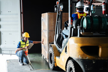 Warehouse worker workers with forklift in a warehouse. Use forklift operator moves packages....
