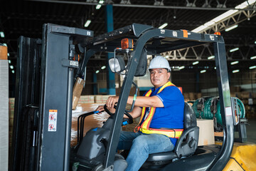 Fototapeta na wymiar Warehouse worker workers with forklift in a warehouse. Use forklift operator moves packages. Concept industrial and commercial.