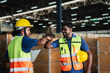 Group warehouse workers shake hands to celebrate and be happy in the warehouse., Industrial and industrial concept.