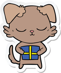 sticker of a cute cartoon dog with christmas present