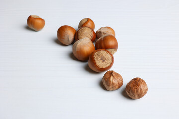 Background for food with hazelnuts, hazelnuts on a light wooden table. Soft focus.