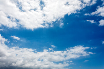 Naklejka na ściany i meble White feathery clouds against a blue sky