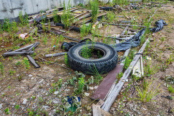 Environment. Car tires and construction debris dumped on the ground