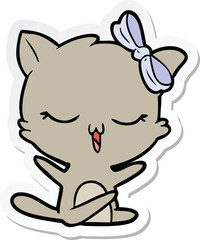 sticker of a cartoon cat with bow on head