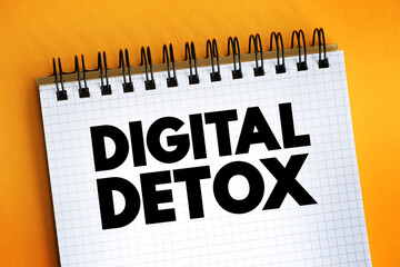 Digital Detox - period of time when a person voluntarily refrains from using digital devices, text on notepad - obrazy, fototapety, plakaty
