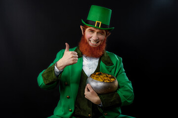 Leprechaun elf on St. Patrick's Day. Cheerful character Irish leprechaun for advertising with a red...