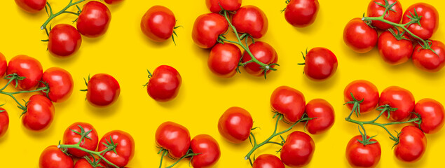Tomato on a branch sprout top view flatlay on a yellow background. Fresh juicy ripe tomato Red Cherry fruits. Salad preparation ingredients