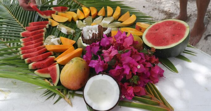 Fruit arrangement - tahiti fruit table with coconut, mango, watermelon, melons etc. Typical local tahitian food presentation from French Polynesia. Travel vacation food